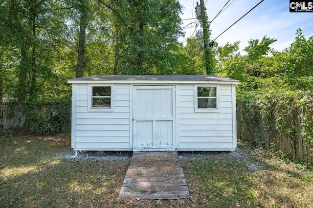 view of shed featuring fence