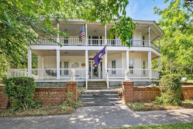 view of front facade featuring covered porch and a balcony