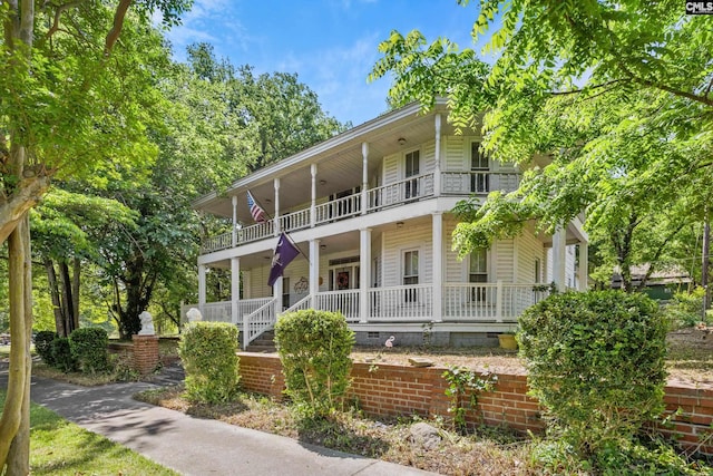 colonial inspired home featuring a porch, crawl space, and a balcony