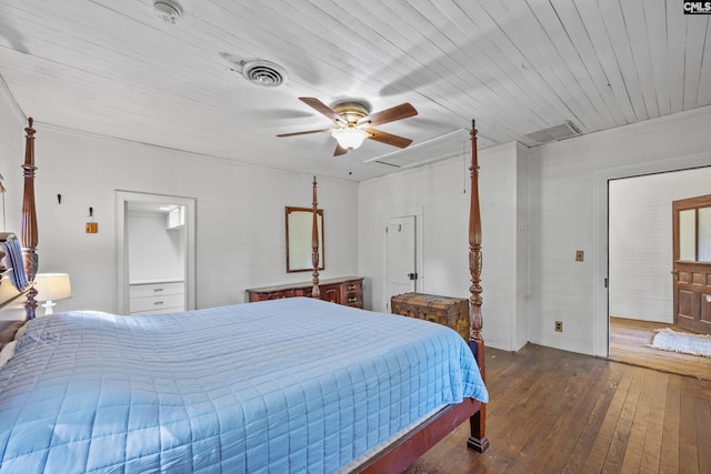 bedroom with ceiling fan, hardwood / wood-style flooring, attic access, and visible vents