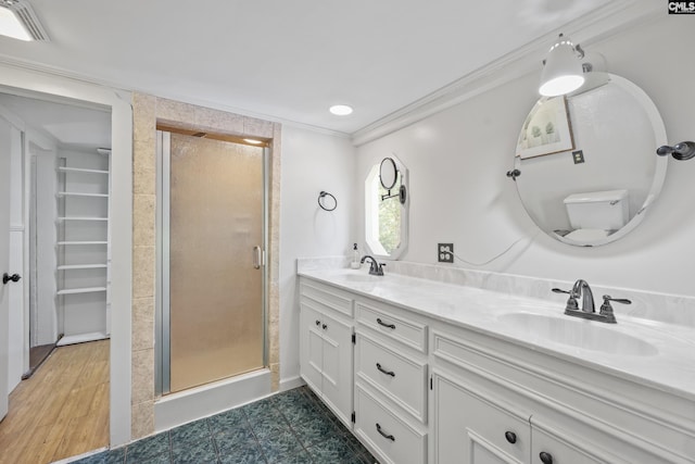 full bath with a sink, ornamental molding, and a shower stall