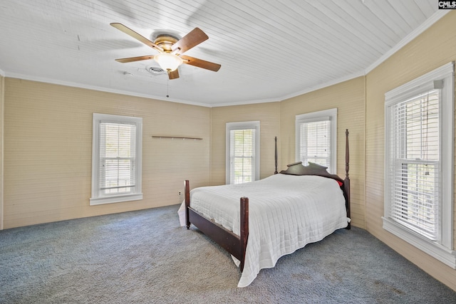 carpeted bedroom featuring ceiling fan, multiple windows, and ornamental molding
