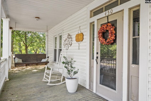 wooden terrace with a porch