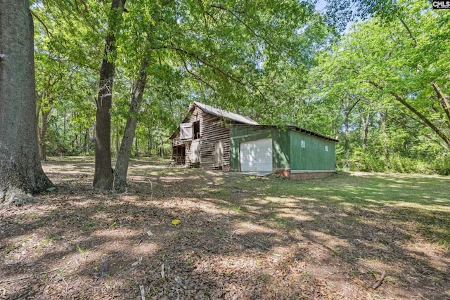 view of side of home featuring an outdoor structure and a detached garage