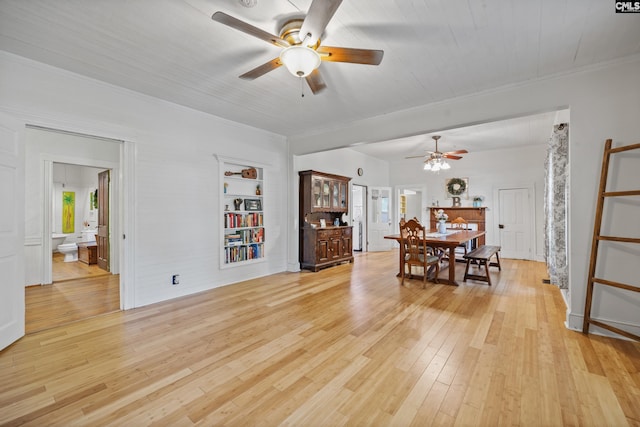 dining room featuring crown molding, light wood-style floors, and a ceiling fan