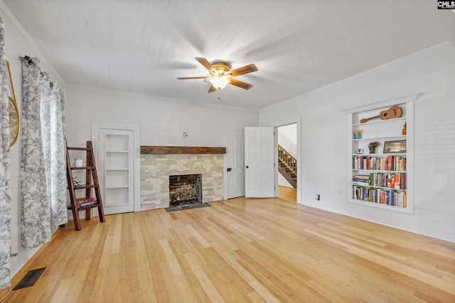 unfurnished living room featuring ceiling fan, visible vents, built in features, and wood finished floors