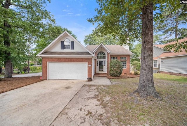 traditional home with brick siding, driveway, a chimney, and a garage