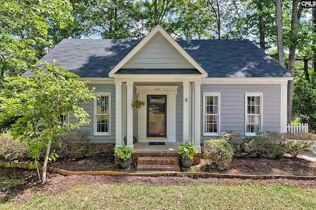 view of front of property with covered porch and a shingled roof