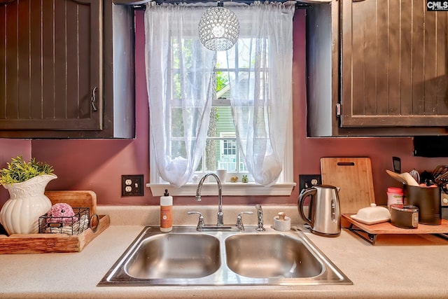 kitchen featuring a wealth of natural light, light countertops, and a sink