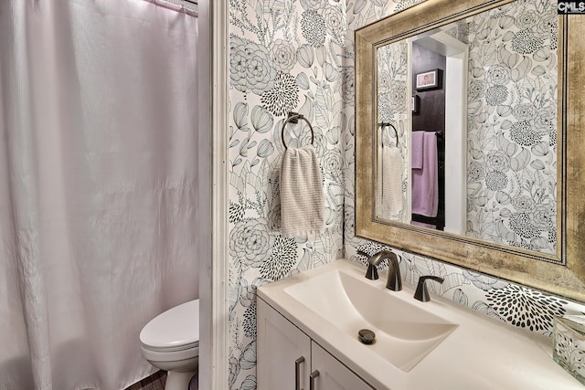 bathroom featuring toilet and vanity