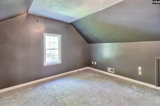 bonus room with vaulted ceiling, carpet flooring, visible vents, and baseboards