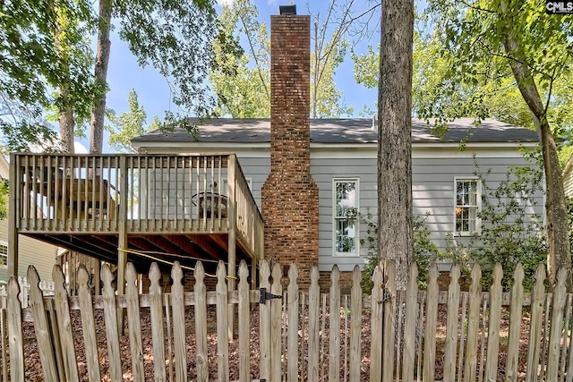 back of house with a wooden deck and fence