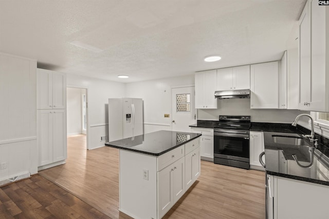5227 Bush River Rd, Columbia, SC 29212 - kitchen with stainless steel range with electric stovetop, white refrigerator with ice dispenser, under cabinet range hood, a sink, and light wood-type flooring