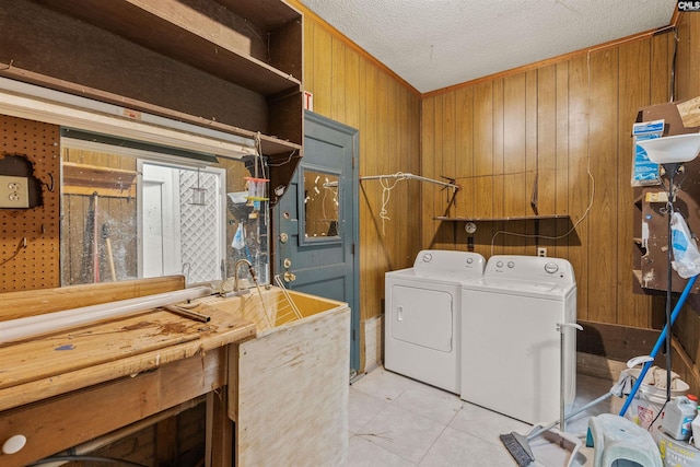 5227 Bush River Rd, Columbia, SC 29212 - laundry area with washing machine and dryer, wooden walls, light tile patterned floors, and a textured ceiling