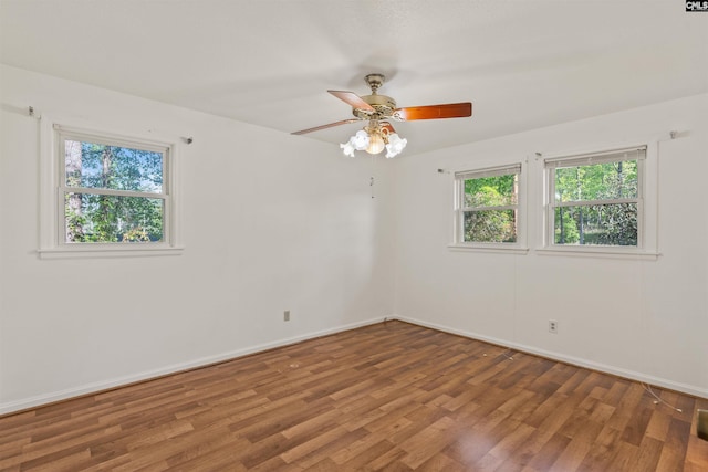 5227 Bush River Rd, Columbia, SC 29212 - spare room featuring plenty of natural light, wood finished floors, baseboards, and a ceiling fan