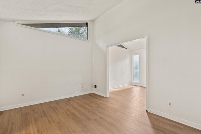 5227 Bush River Rd, Columbia, SC 29212 - empty room featuring wood finished floors, baseboards, and a textured ceiling