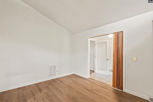 5227 Bush River Rd, Columbia, SC 29212 - unfurnished room featuring wood finished floors, baseboards, and lofted ceiling
