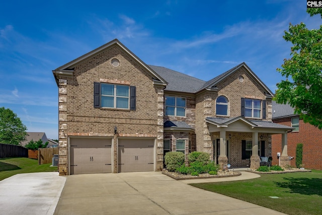 craftsman-style home with brick siding, driveway, fence, and a front yard