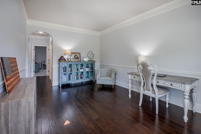 home office featuring ornamental molding, arched walkways, baseboards, and wood finished floors