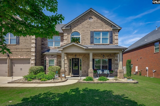 view of front facade with a porch, brick siding, concrete driveway, a garage, and a front lawn