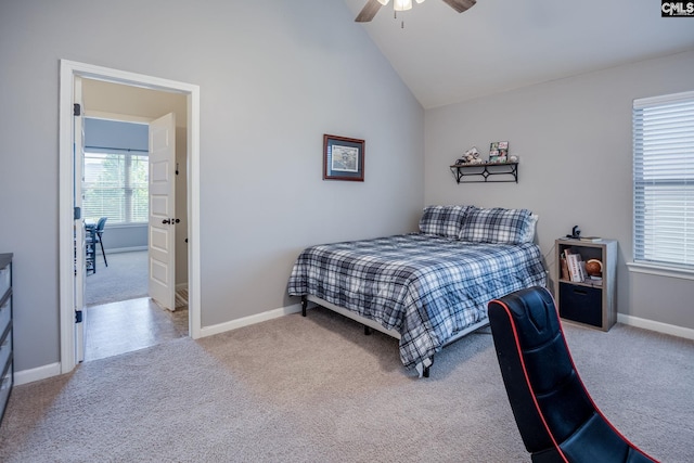 carpeted bedroom with baseboards, ceiling fan, and vaulted ceiling