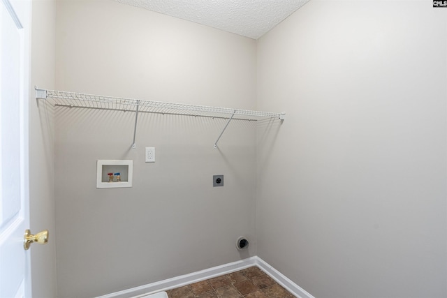 laundry area featuring laundry area, hookup for an electric dryer, stone finish flooring, baseboards, and hookup for a washing machine