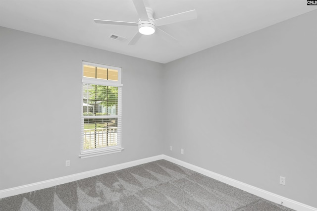 unfurnished room with carpet floors, baseboards, a ceiling fan, and visible vents