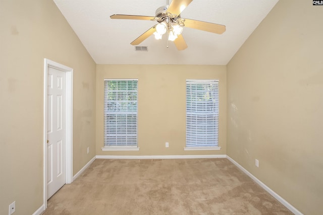 unfurnished room featuring baseboards, ceiling fan, light carpet, and visible vents