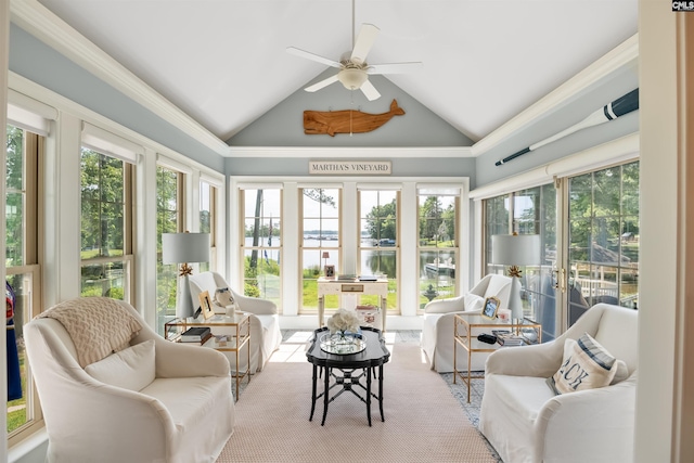 sunroom / solarium featuring a water view and lofted ceiling