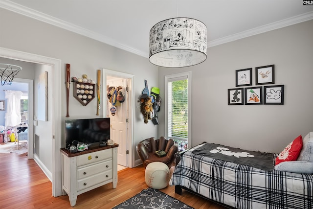 bedroom with light wood finished floors, baseboards, and ornamental molding