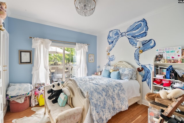 bedroom with hardwood / wood-style floors, crown molding, and access to exterior