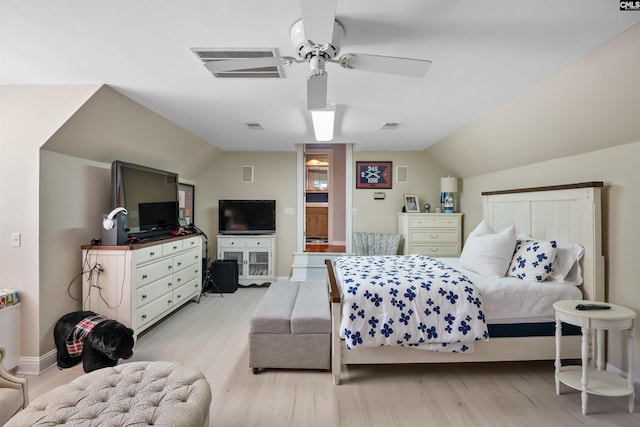 bedroom with lofted ceiling, a ceiling fan, baseboards, visible vents, and light wood-style floors