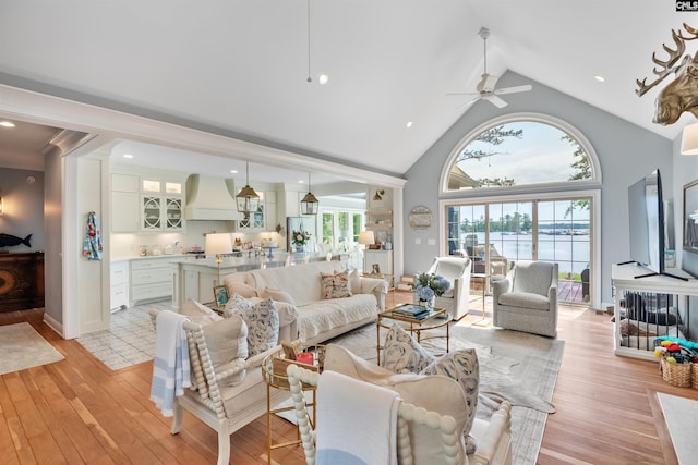 living area featuring recessed lighting, light wood-type flooring, ceiling fan, and high vaulted ceiling