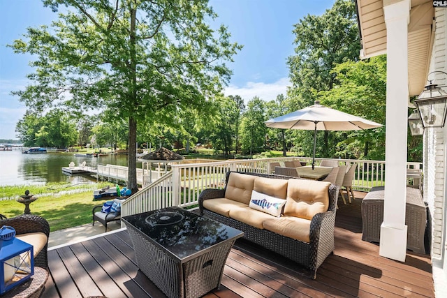 wooden deck with an outdoor hangout area and a water view