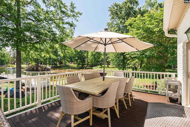 wooden terrace featuring a water view and outdoor dining area