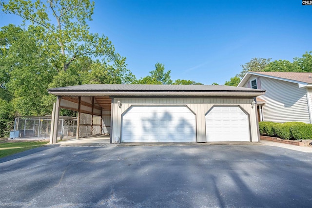 garage with a garage and fence