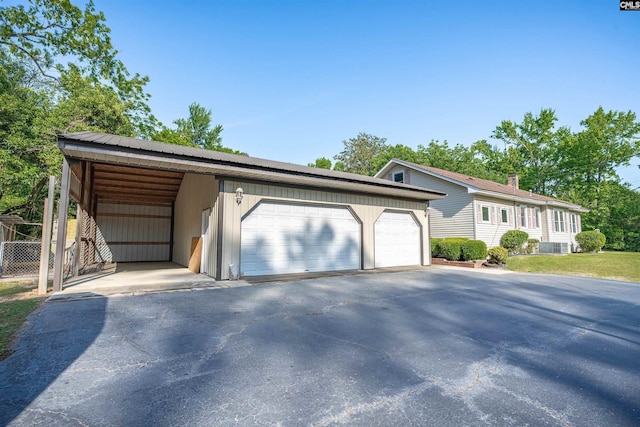 view of front facade with metal roof, an outdoor structure, and a garage