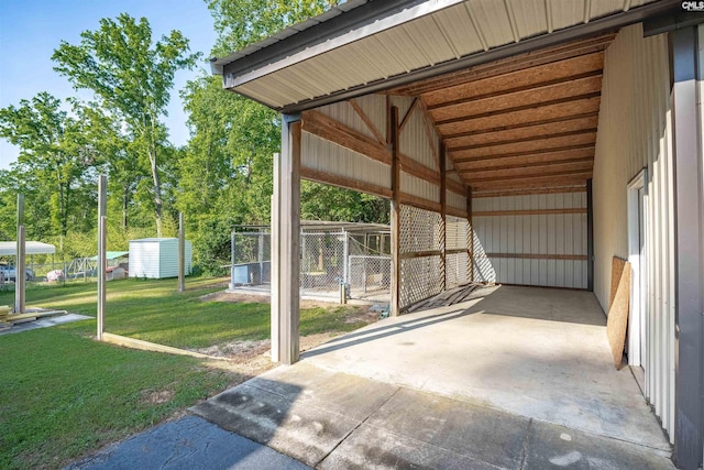 view of car parking with fence and a carport