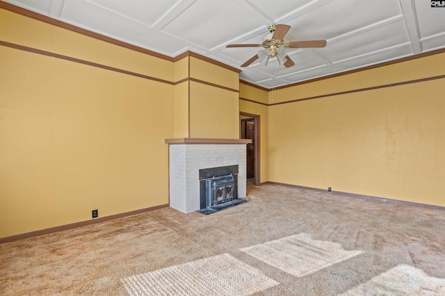 unfurnished living room with coffered ceiling, ceiling fan, a brick fireplace, and carpet floors