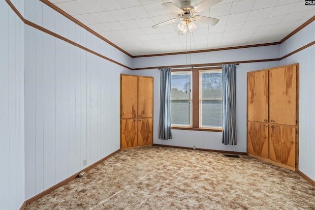 spare room featuring a ceiling fan, ornamental molding, carpet, and baseboards