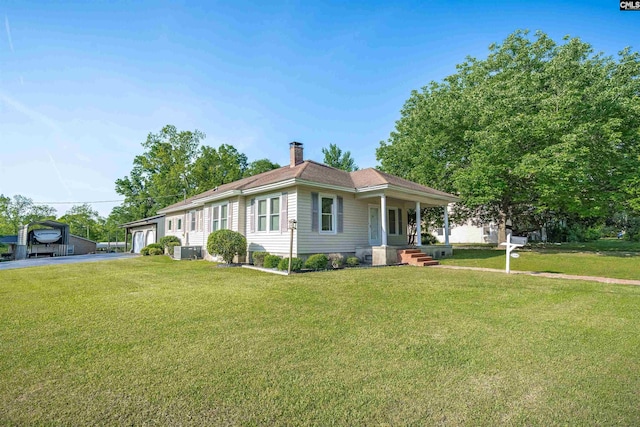 view of front facade featuring a chimney and a front lawn