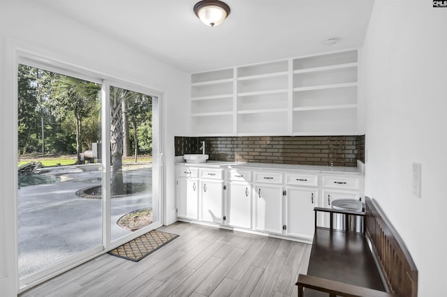 15 Glenlake Rd, Columbia, SC 29223 - kitchen with light wood-style flooring, white cabinetry, open shelves, backsplash, and light countertops