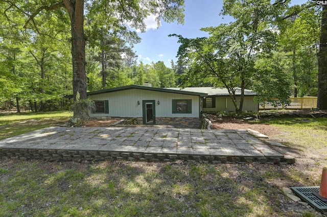 back of house with stone siding