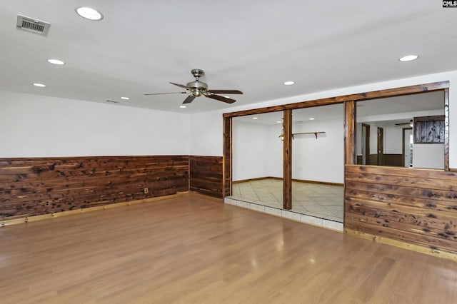 empty room featuring visible vents, wood finished floors, ceiling fan, and recessed lighting