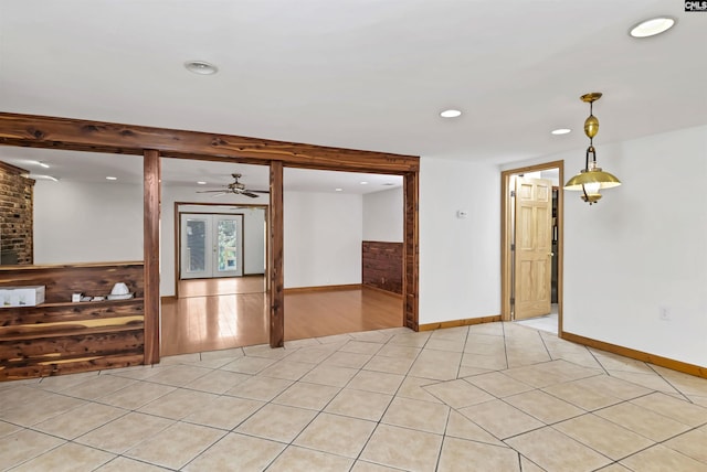 empty room featuring light tile patterned floors, baseboards, and recessed lighting