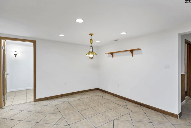 empty room with baseboards, light tile patterned floors, and recessed lighting