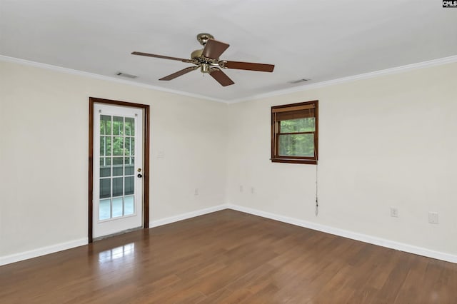 empty room with ornamental molding, visible vents, wood finished floors, and a healthy amount of sunlight