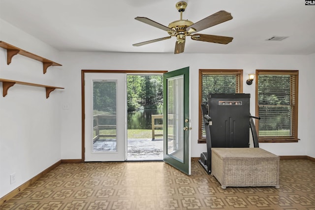 entryway with baseboards, a ceiling fan, and visible vents