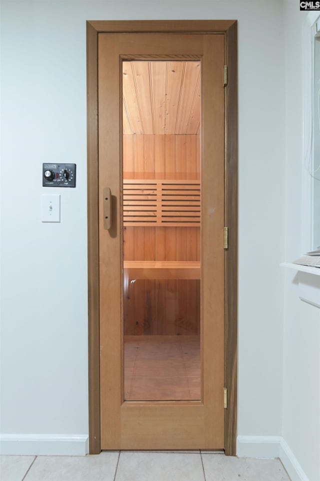 view of sauna / steam room featuring baseboards and tile patterned flooring