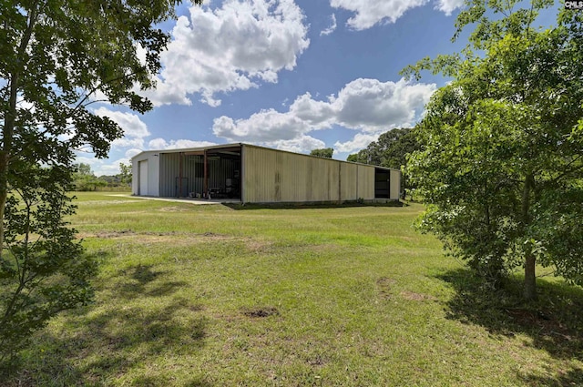 view of yard featuring an outbuilding, an outdoor structure, and a detached garage
